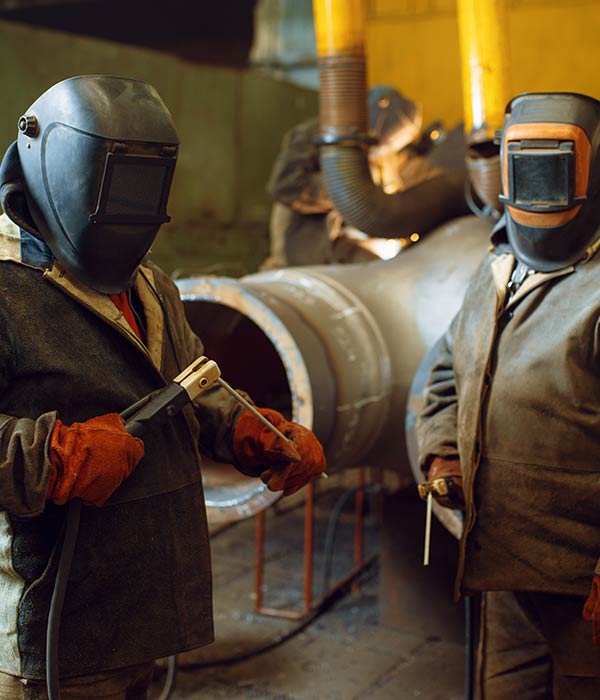 two-welder-in-masks-prepares-to-work-with-metal-KTPAD5L.jpg